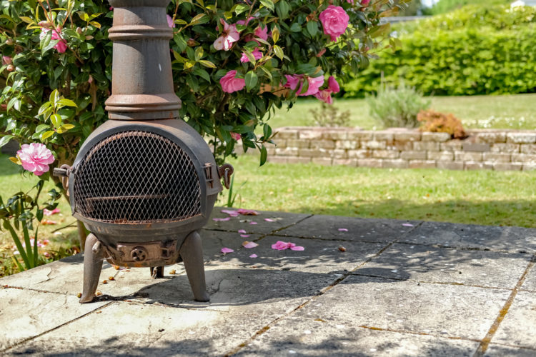 garden heating ideas with a traditional chiminea on a patio
