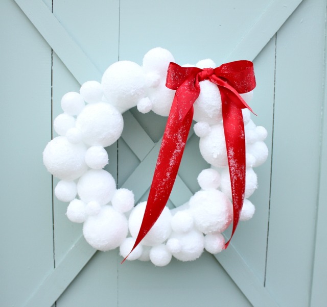 a wreath made from white spheres that look like snowballs