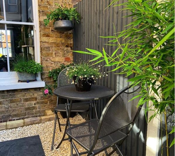 a snug seating area with black bistro table and chairs