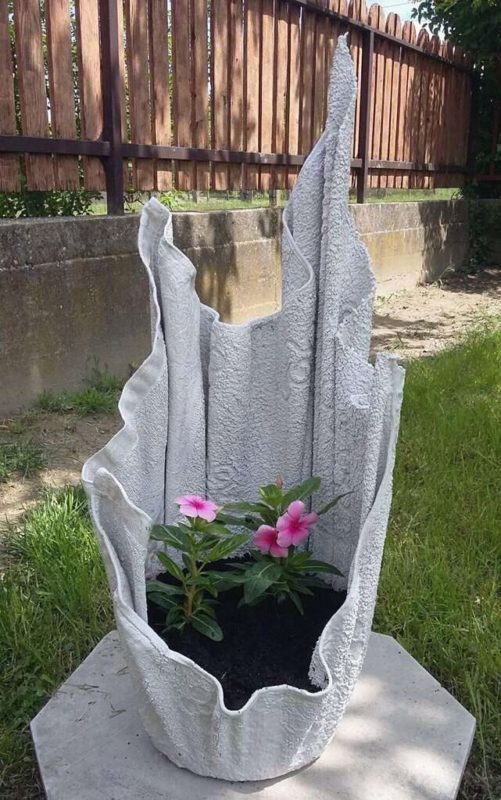 a concrete planter that looks like fabric mysteriously draping upwards