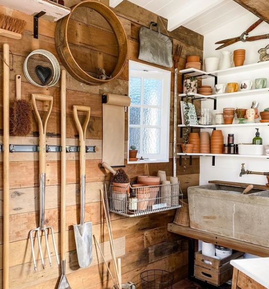 14 Garden Tool Storage Ideas: Keeping Your Shed Ship-Shape 11 an organised shed with wall mounted tools and tidy shelves with pots