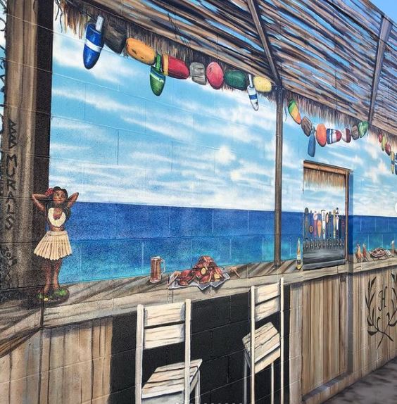 29 Unique Garden Mural Ideas for Outdoor Walls & Fences 27 a realistic painting of a beach bar creating an illusion that the garden is much bigger
