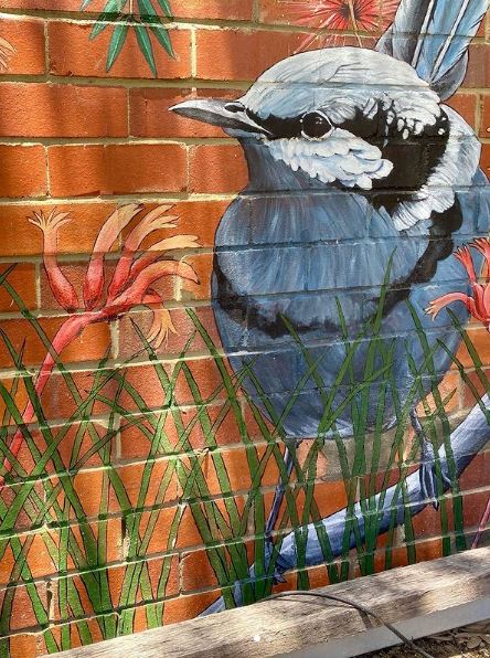 29 Unique Garden Mural Ideas for Outdoor Walls & Fences 18 a close-up of a mural of a bird