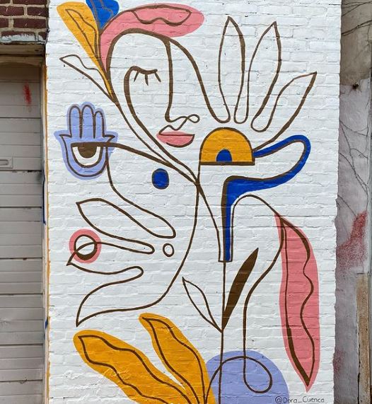 29 Unique Garden Mural Ideas for Outdoor Walls & Fences 19 a creative line drawing with abstract depictions on a white brick wall