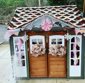 garden playhouse ideas with festive DIY decorations to make it look like a gingerbread house with icing and sweets