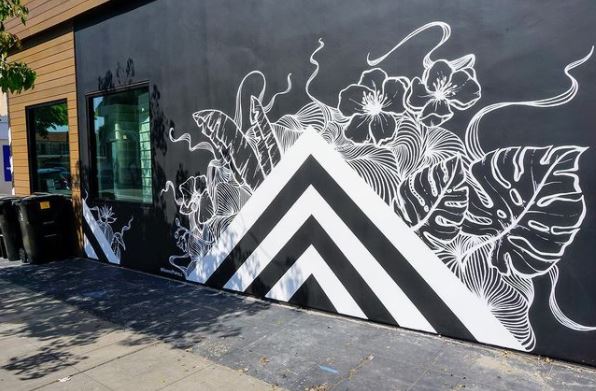 garden mural ideas with a series of concentric white triangles, surrounded by organic plant shapes