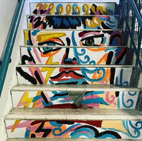 29 Unique Garden Mural Ideas for Outdoor Walls & Fences 25 steps with a stylised portrait painted going up the risers of each step