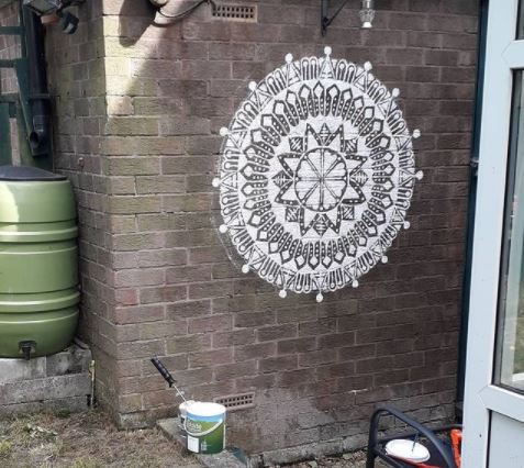 29 Unique Garden Mural Ideas for Outdoor Walls & Fences 5 an intricate mandala painted on a garden wall