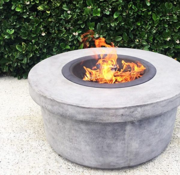 a circular fire pit made from concrete