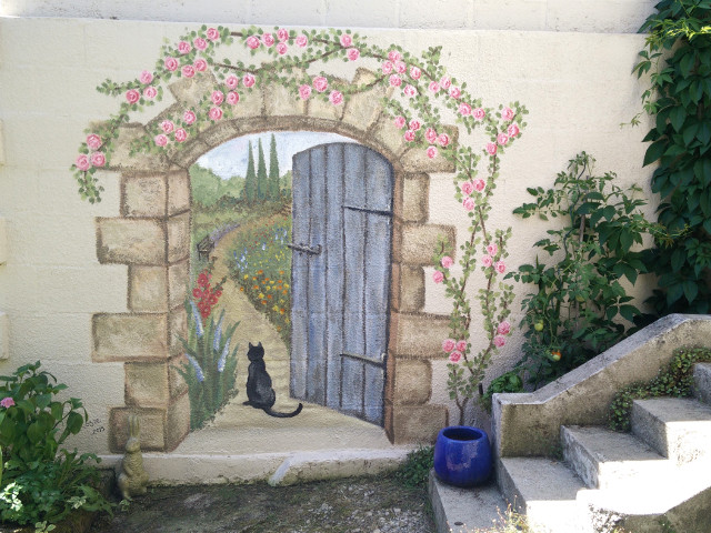 29 Unique Garden Mural Ideas for Outdoor Walls & Fences 28 a painted doorway that appears to lead to a secret garden