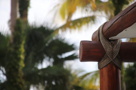 a close up of wooden poles being held together with twine to create furniture