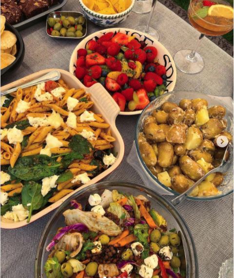 A table of delicious home-cooked food featuring garden vegetables
