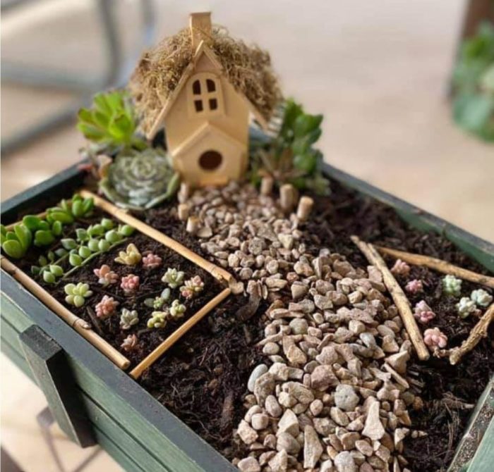 a small wooden crate used to contain a farm-themed fairy garden