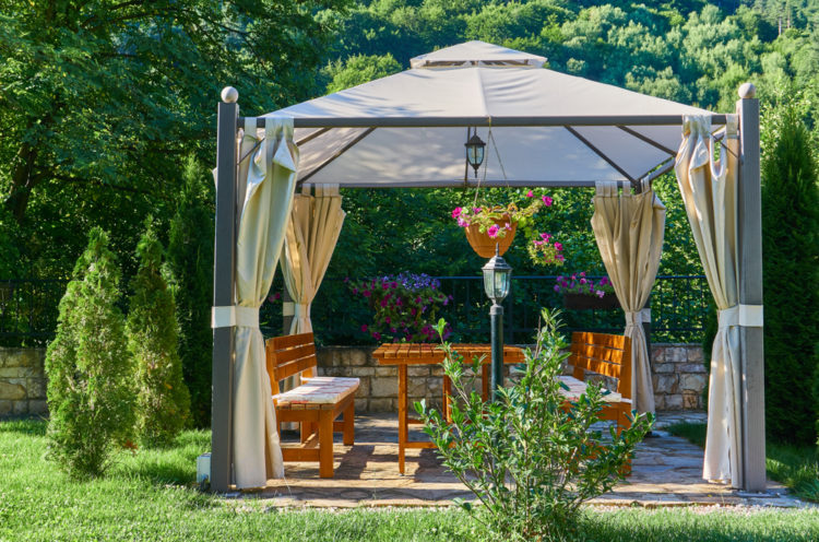 18 Garden Gazebo Ideas for an Outdoor Shelter from the Sun 10 a metal-framed gazebo with luxurious canvas curtains
