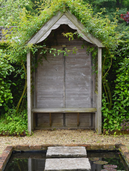 18 Garden Gazebo Ideas for an Outdoor Shelter from the Sun 3 a modest wooden arbour with a solid back and scalloped roof