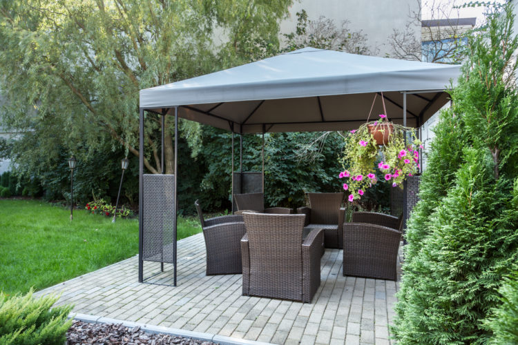 18 Garden Gazebo Ideas for an Outdoor Shelter from the Sun 1 a spacious patio with a large, metal-framed gazebo over garden furniture