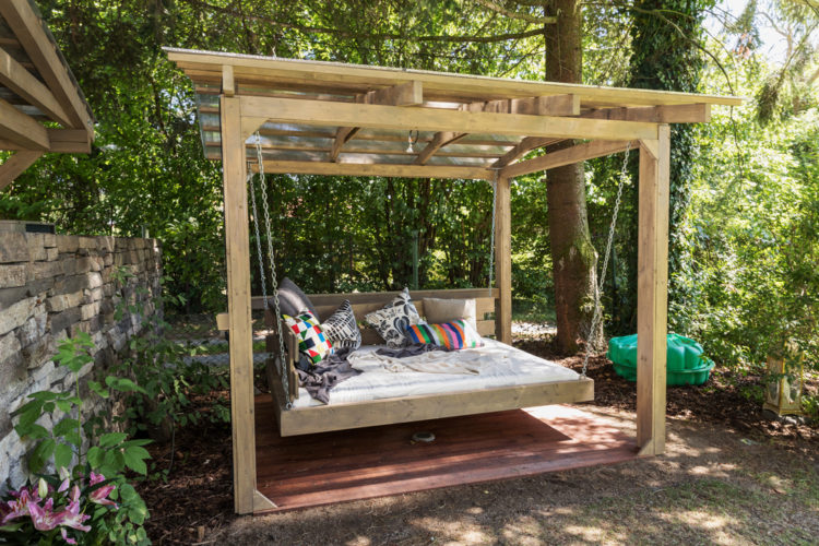 18 Garden Gazebo Ideas for an Outdoor Shelter from the Sun 14 a large hanging bench in the style of a cabana