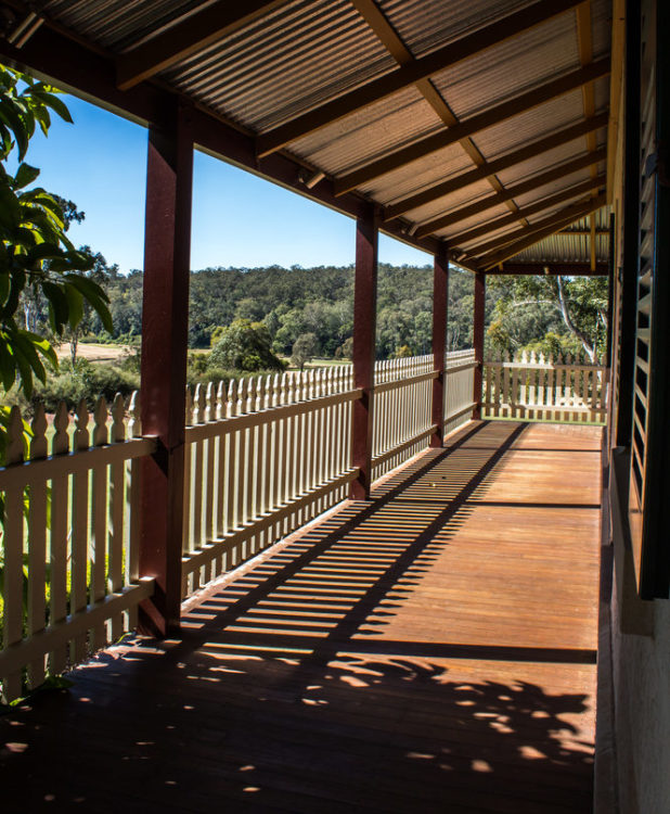 18 Garden Gazebo Ideas for an Outdoor Shelter from the Sun 5 a long, American-style veranda on the side of a house, overlooking a garden