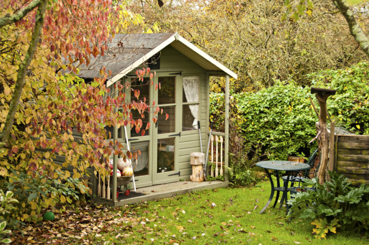 18 Garden Gazebo Ideas for an Outdoor Shelter from the Sun 4 a summerhouse style shed surrounded by autumnal foliage