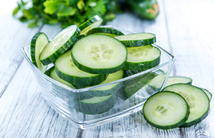 How to Grow Cucumbers in Your Garden 1 a glass dish filled with slices of fresh cucumber