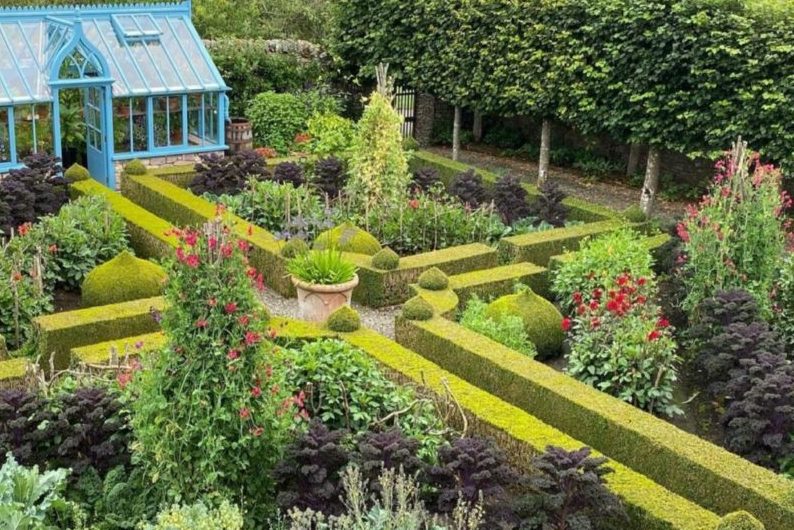 a beautiful, symmetrical kitchen garden with box hedge borders