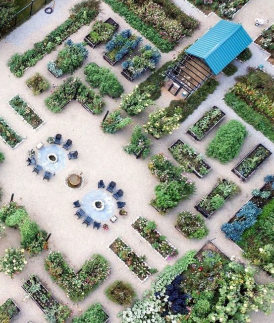 a birds-eye view of a large foodscape with plants in containers on gravel