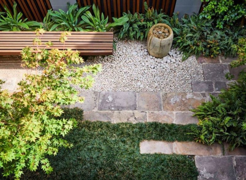 minimalist garden ideas can still have a grass area, hardscaped section and lots of plants, like this Japanese inspired space