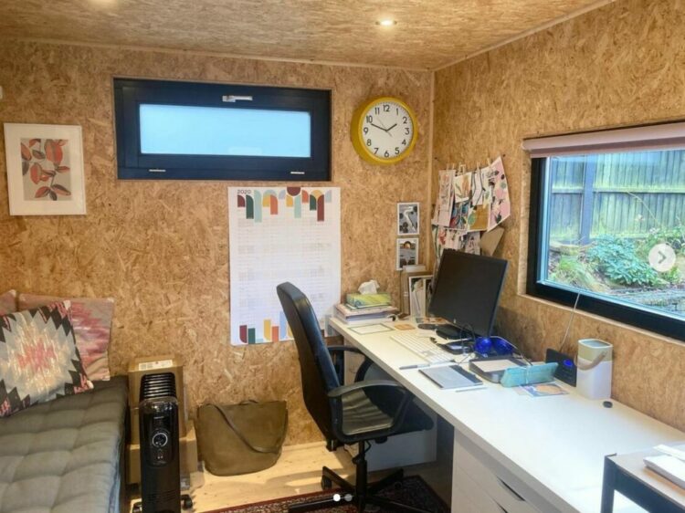 garden office interior ideas with bare chipboard used as a creative pinboard