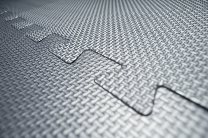 a close up of interlocking rubber floor tiles, good for weightlifting