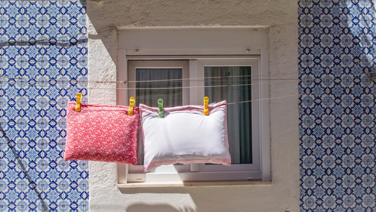 garden furniture cushions drying on a line