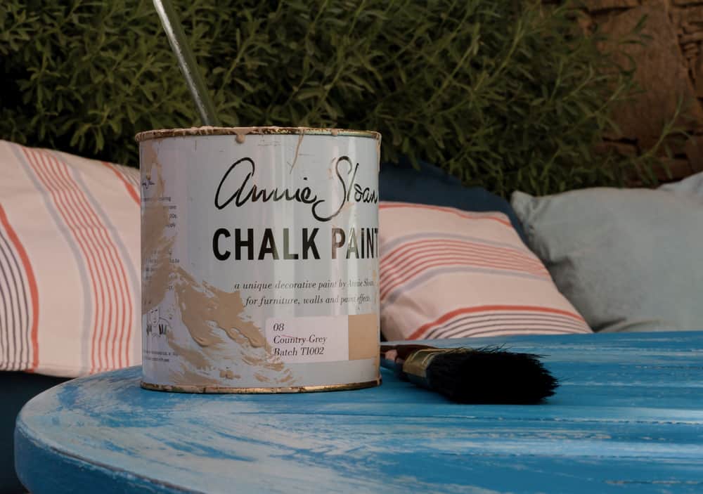 How to Paint Garden Furniture 5 chalk paint on the vintage table next to the paintbrush