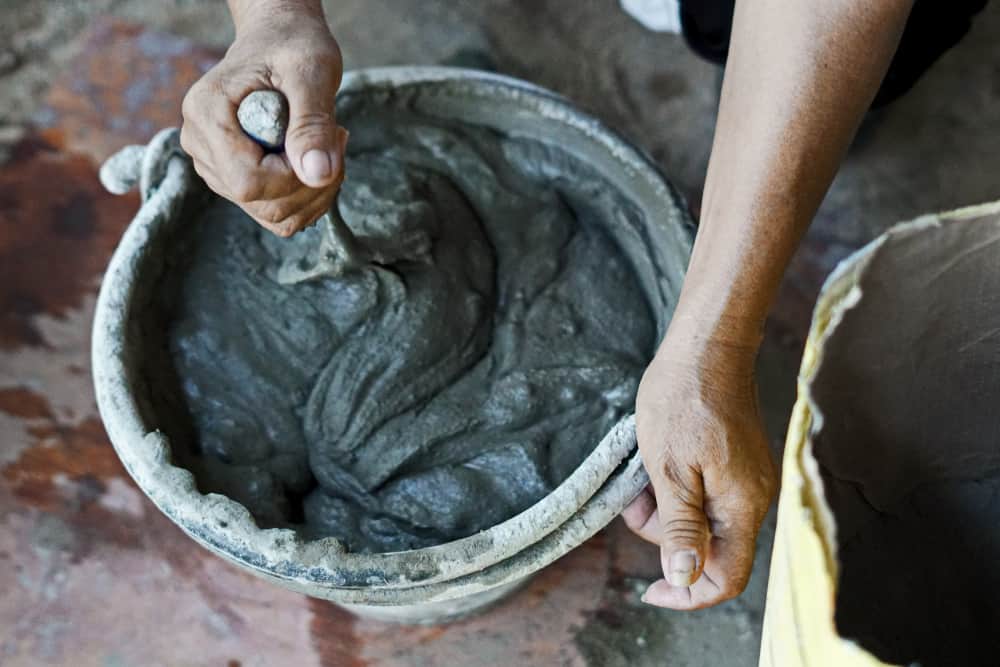 How to Make a DIY Concrete Planter Box in 5 Simple Steps 2 mixing cement in the bucket mixer