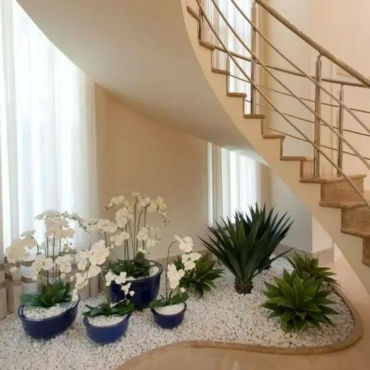 white orchids & pebbles under the staircase