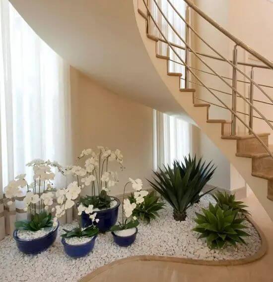 15 Indoor Pebble Garden Under Stairs Ideas: Mini Zen Areas 5 white orchids & pebbles under the staircase